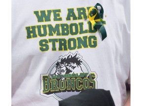 A man wears a Humboldt Broncos shirt.