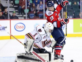 Calgary Hitmen goaltender Trevor Martin stops Lethbridge Hurricanes forward Jadon Joseph during WHL action at the Scotiabank Saddledome on January 15, 2017.