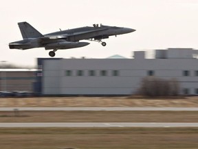 A pilot takes off during the departure of CF-18 Hornets in support of Operation IMPACT, in Cold Lake, Alberta on Tuesday October 21, 2014. A National Defence investigation suggests that pilot distraction was the likely cause of a fatal CF-18 crash near Cold Lake, Alta., in November 2016.