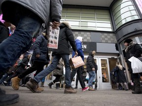 Shoppers pass in front of a store in downtown Montreal, Quebec.