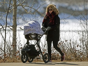 Kira Gregson took her 3-month-old son Ford for a stroll down River Valley Road in Edmonton on Thursday April 5, 2018. Temperatures in the region hovered aroud -10C degrees, one of the coldest spring seasons on record.
