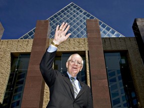 Edmonton Coun. Ron Hayter waves in front City Hall as he poses for a photo. Hayter is the longest serving councillor in Edmonton's history.