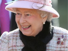 Queen Elizabeth II wears a Hillberg & Berk tourmaline, diamond and freshwater pearl brooch in 2014.