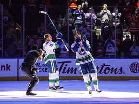Vancouver Canucks' Henrik Sedin (33) and Daniel Sedin (22) wave to the crowd after the game against the Edmonton Oilers in Edmonton, Alta., on Saturday April 7, 2018.