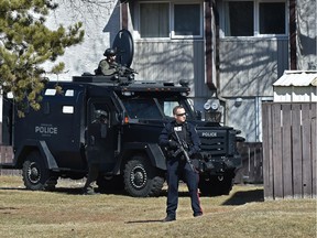 The police tactical unit surround a complex on 82 Street near 144 Avenue in Edmonton, April 23, 2018.