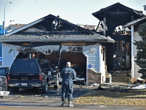 Fire investigators on the scene of a house fire at 4028 22 Ave. in Mill Woods that broke out in the early morning hours, sending two people to hospital, on Thursday, April 19, 2018.