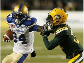 Edmonton's Kenny Ladler (37) attempts to tackle Winnipeg Blue Bomber Ryan Lankford (84) during the first half of a CFL football game between the Edmonton Eskimos and the Winnipeg Blue Bombers at Commonwealth Stadium on Saturday, September 30, 2017.