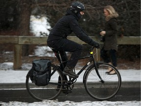 A cyclist rides along 83 Avenue in the bike lane in winter gear during a snowstorm in Edmonton on Jan. 25, 2018. Edmonton, Alberta on Thursday, Jan. 25, 2018.