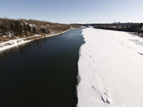 The North Saskatchewan River appears half melted from a bridge over the river at Rundle Park in Edmonton, on Monday, April 2, 2018.