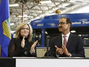 Sandra Jansen, Alberta Minister of Infrastructure (left) and  Amarjeet Sohi, federal Minister of Infrastructure and Communities, sign a bilateral agreement that will provide more than $3.3 billion in federal funding for infrastructure at the Edmonton Transit System's Centennial Garage in Edmonton, on Tuesday, April 3, 2018.