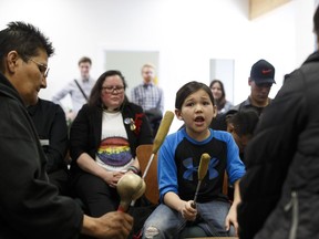 From left: Carol Powder; Noah Green, 8; Shacony Green and Ricky Tahotha (not shown) with Chubby Cree perform a drum song during the grand opening of the Pride Centre of Edmonton's new community space at 10618 105 Ave. in Edmonton, on Wednesday, April 4, 2018.