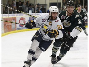 Spruce Grove Saints' Josh Harris (21) battles Okotoks Oilers Kylor Wall (2) during the first period of Game 4 of the AJHL finals at Grant Fuhr Arena in Spruce Grove, on Tuesday, April 17, 2018.