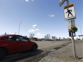 A pedestrian was hit by a vehicle around 11 p.m. Sunday, April 15, at a crosswalk with lights activated at Tower Road and Kingsway in Edmonton, on Wednesday, April 18, 2018. Flowers were displayed at the intersection on Wednesday, placed there by her friends and family.