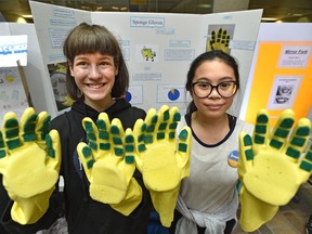 Uma Shepherd, 12, left, and Rhyzel Velasquez, 12, Grade 7 students at Victoria School, show-off their sponge gloves invention that help you wash dishes