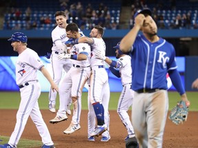 Toronto Blue Jays players celebrate their walk-off win over the Kansas City Royals on April 17.