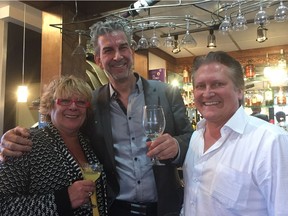 (From left) Manor Bistro co-owners Lisa Dungale and chef Cyrille Koppert, and customer Peter Koziol, celebrate the bistro's 25th anniversary with an open house at the restaurant.