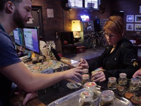 Pot shops similar to this Denver outlet, where a "budtender" deals with a customer, will soon open in Edmonton as Canada prepares to legalize recreational marijuana.