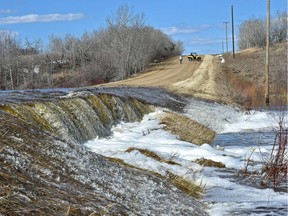 Local farmer Albert Palley surveyed the waterfall spilling over Range Road 163 near Township Road 562 from a 20 foot high gully, full of water in Lamont County, a few kilometres southeast of the town of Andrew, northeast of Edmonton, April 25, 2018.
