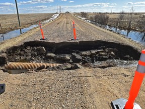 The road collapsed around a culvert on Range Road 163 near Township Road 562 near Highway 29 in Lamont County, about 10 kilometres southeast of the town of Andrew, northeast of Edmonton, April 25, 2018. Numerous overland flooding alerts throughout Alberta from mainly snow melting has caused the alerts over the last nine days.