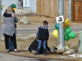 People coming to pay their respects at a memorial outside the parents home of Humboldt Broncos goalie Parker Tobin in Stony Plain, April 9, 2018. Tobin was one of the players killed in the Broncos bus crash Friday in northern Saskatchewan. Ed Kaiser/Postmedia