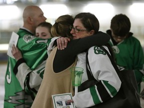 Cory Anne Holmlund (right) is hugged during a vigil held at the Omniplex in Drayton Valley on Tuesday, April 10, 2018. She was Parker Tobin's billet mother. The hockey player for the SJHL Humboldt Broncos team was one of the players who died in a fatal bus crash when the team bus collided with a semi-trailer on a Saskatchewan highway. Parker Tobin was mistakenly believed to have survived the crash but it was later learned that he had been misidentified with teammate Xavier Labelle, who did survive.