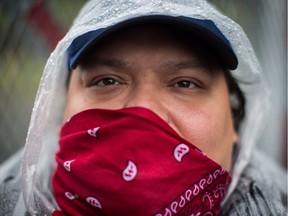 Arnold Paul, of the Sliammon First Nation, joins other protesters opposed to the Kinder Morgan Trans Mountain pipeline extension in defying a court order and blocking an entrance to the company's property, in Burnaby, B.C., on Saturday April 7, 2018.