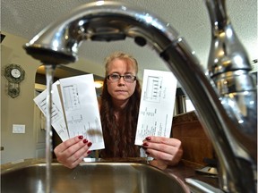 Holding unusually high water untility bills is Trina Okimaw-Scott, homeowner and founder of Fort Saskatchewan Water Wars Facebook group after Service Alberta Minister Stephanie McLean announced tabling of new legislation that would better protect water consumers by giving them a new way to resolve billing disputes.