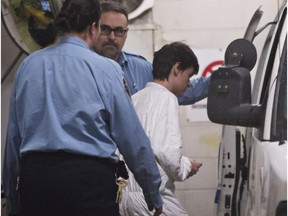 Alexandre Bissonnette is escorted to a van after appearing in court in Quebec City.