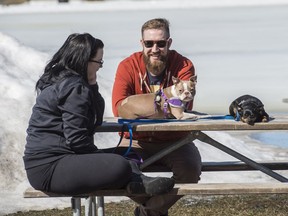 Jennifer Warren and William Worsulak with dogs Bruno and Penny enjoy a warm Edmonton spring day in Hawrelak Park on Saturday, April 13, 2018