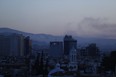 Smoke rises after airstrikes targeting different parts of the Syrian capital Damascus, Syria, early Saturday, April 14, 2018.