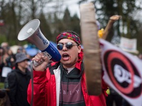 Cedar George-Parker addresses the crowd as protesters opposed to the Kinder Morgan Trans Mountain pipeline extension defy a court order and block an entrance to the company's property, in Burnaby, B.C., on April 7, 2018.
