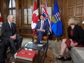Prime Minister Justin Trudeau, B.C. Premier John Horgan, left, and Alberta Premier Rachel Notley, sit in Trudeau's office on Parliament Hill for a meeting on the deadlock over Kinder Morgan's Trans Mountain pipeline expansion, in Ottawa on Sunday, April 15, 2018.