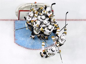 Vegas Golden Knights players mob goaltender Marc-Andre Fleury to celebrate their sweep of the Los Angeles Kings on April 17.