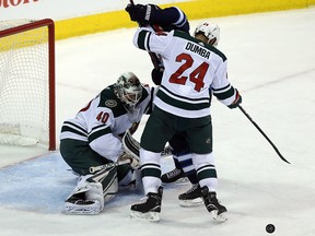 Minnesota Wild goaltender Devan Dubnyk makes a save as defenceman Matt Dumba and Winnipeg Jets centre Paul Stastny battle during Game 2 of their first-round NHL playoff series in Winnipeg on Fri., April 13, 2018. (Kevin King/Winnipeg Sun)