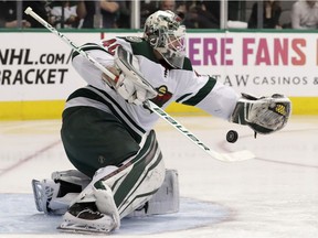 Minnesota Wild goalie Devan Dubnyk reaches out to stop a shot by the Dallas Stars during NHL action on March 31, 2018, in Dallas.
