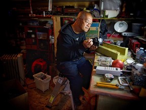 Ricky Lee works in his train shop on one of his 30 engines and 85 pieces of rolling train stock.