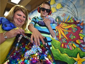 Kristi Rouse and her son, Nathan, prepare to enjoy the St. Albert International Children's Festival. Nathan has autism spectrum disorder and can use a kit containing ear protection, sunglasses and textured pillows.