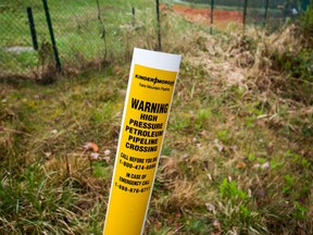 A petroleum pipeline crossing marker stands near the Kinder Morgan facility in Burnaby, British Columbia.