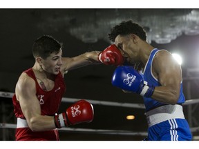 Wyatt Sanford (in red) fights Hassan Omar (in Blue) during the finals of the Light Welter (64kg) weight category during the 2018 Canadian Boxing Nationals, in Edmonton Sunday April 1, 2018.