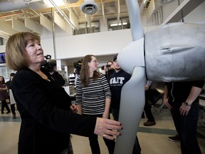 Minister of Energy Margaret McCuaig-Boyd looks at a wind turbine in the Alternative Energy Technology Lab at NAIT, after announcing the next stage of private-sector competitions under Alberta’s Renewable Electricity Program, in Edmonton Wednesday April 4, 2018.