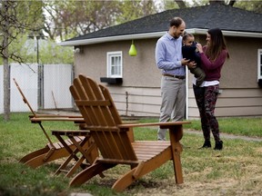 Scott Wright, Alexia Wright, and their son Luca Wright, 2, in the backyard of their Grovenor home.