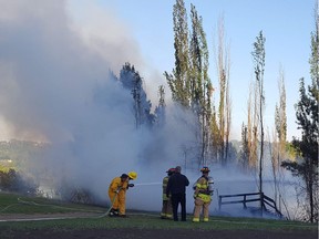 Wooden staircase in Louise McKinney Park is engulfed in flame on May 19, 2018.