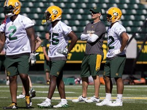 (second from right) Head Coach Jason Maas watches the opening day of the Edmonton Eskimos' training camp at Commonwealth Stadium, in Edmonton Sunday May 20, 2018. Photo by David Bloom