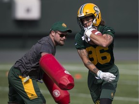 Aaron Grymes , right, takes part in the second day of the Edmonton Eskimos' training camp at Commonwealth Stadium, in Edmonton Monday May 21, 2018.
