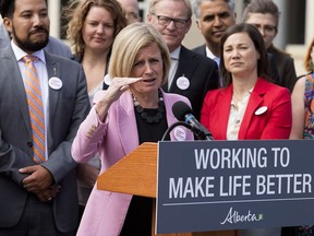 Surrounded by members of her NDP caucus, Alberta Premier Rachel Notley announces that the Government of Canada has purchased the Trans Mountain Pipeline and associated assets, during a press conference outside the Alberta Legislature in Edmonton on Tuesday, May 29, 2018.