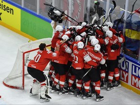 Switzerland's players celebrate after the semifinal match Canada vs Switzerland of the 2018 IIHF Ice Hockey World Championship at the Royal Arena in Copenhagen, Denmark, on May 19, 2018. (JOE KLAMAR/AFP/Getty Images)