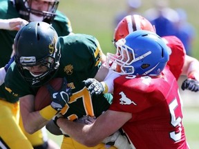 South team's Nils Haeni (#54) of Olds tackles North team's Parker Cullum (#27) of Fort Saskatchewan in Football Alberta's 29th Annual Senior Bowl on Monday, May 21, 2018.