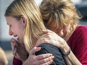 Santa Fe High School student Dakota Shrader is comforted by her mother Susan Davidson following a shooting at the school on Friday, May 18, 2018, in Santa Fe, Texas. Shrader said her friend was shot in the incident.  (Stuart Villanueva/The Galveston County Daily News via AP) ORG XMIT: TXGAL201