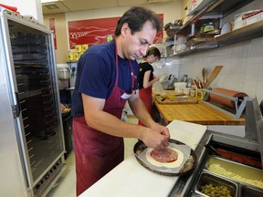 Battista Vecchio puts together a calzone at Battista's Calzone, which is on the Eats on 118 tour in June.