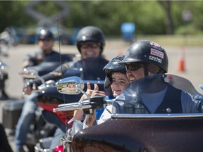 Curtis Morfitt gives Hudson Whalley, 6 a ride with at  Hawrelak Park.  Kids with Cancer got a tour of the Park as a fundraiser as part of Revving up for Kids on May 20, 2018 in Edmonton.